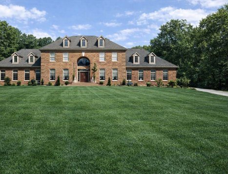 Ashford Manor, a brick Georgian manor home with dormers and a two-story arched entry