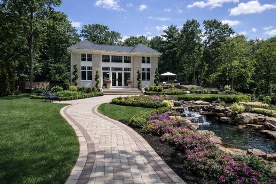 The Grand Tennis Pavilion, a Sudon Brothers estate building with a curved paver walk, waterfall and gardens