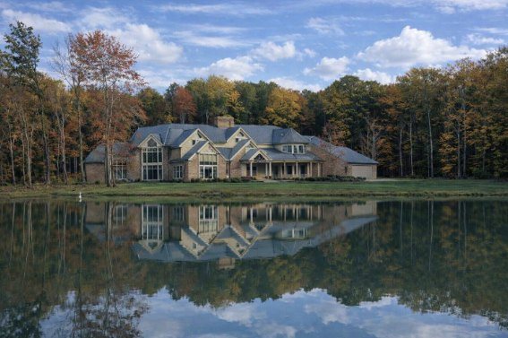 Timberlake Manor, a multi-gabled Sudon Brothers estate home reflected in a private pond in autumn