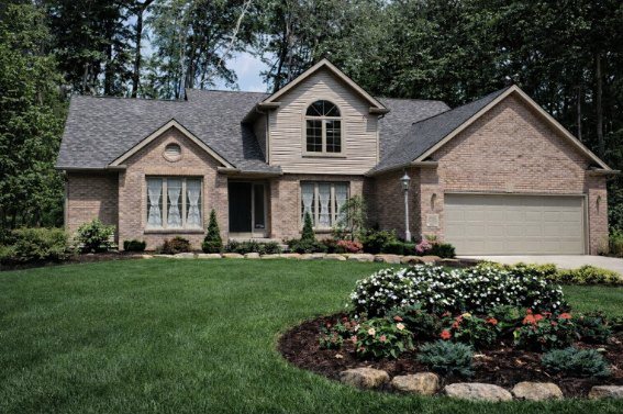 Westhaven, a brick and siding custom home with a landscaped front garden